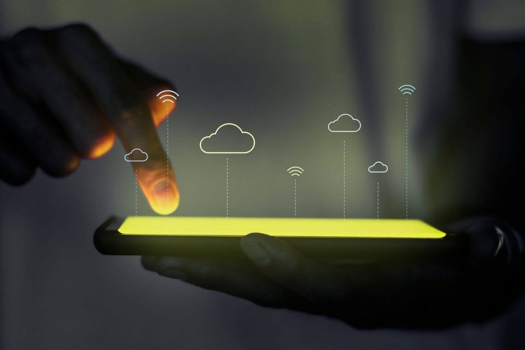 A person holding a phone screen with holographics of Cloud